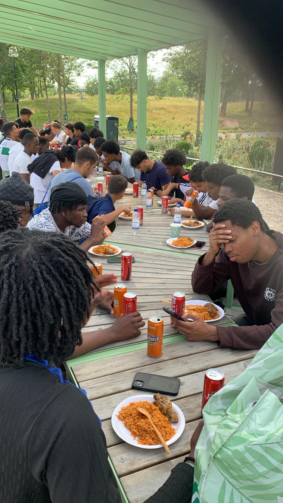members of the nigerian association eating outdoors