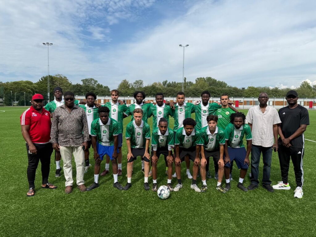 Nigerian Association in Uppsala football team posing together on the field